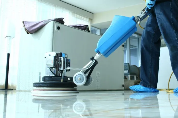 Professional floor machine polishing a marble office floor