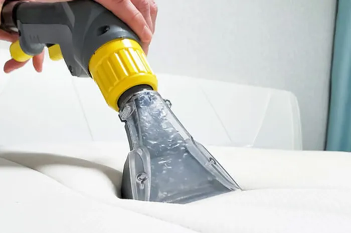 Extraction machine deep cleaning and sanitising a white mattress