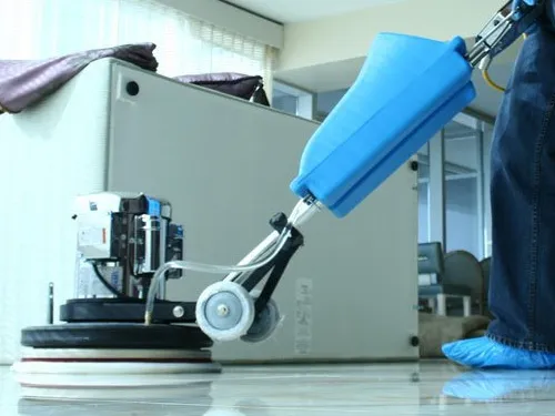 Professional floor machine polishing a marble office floor